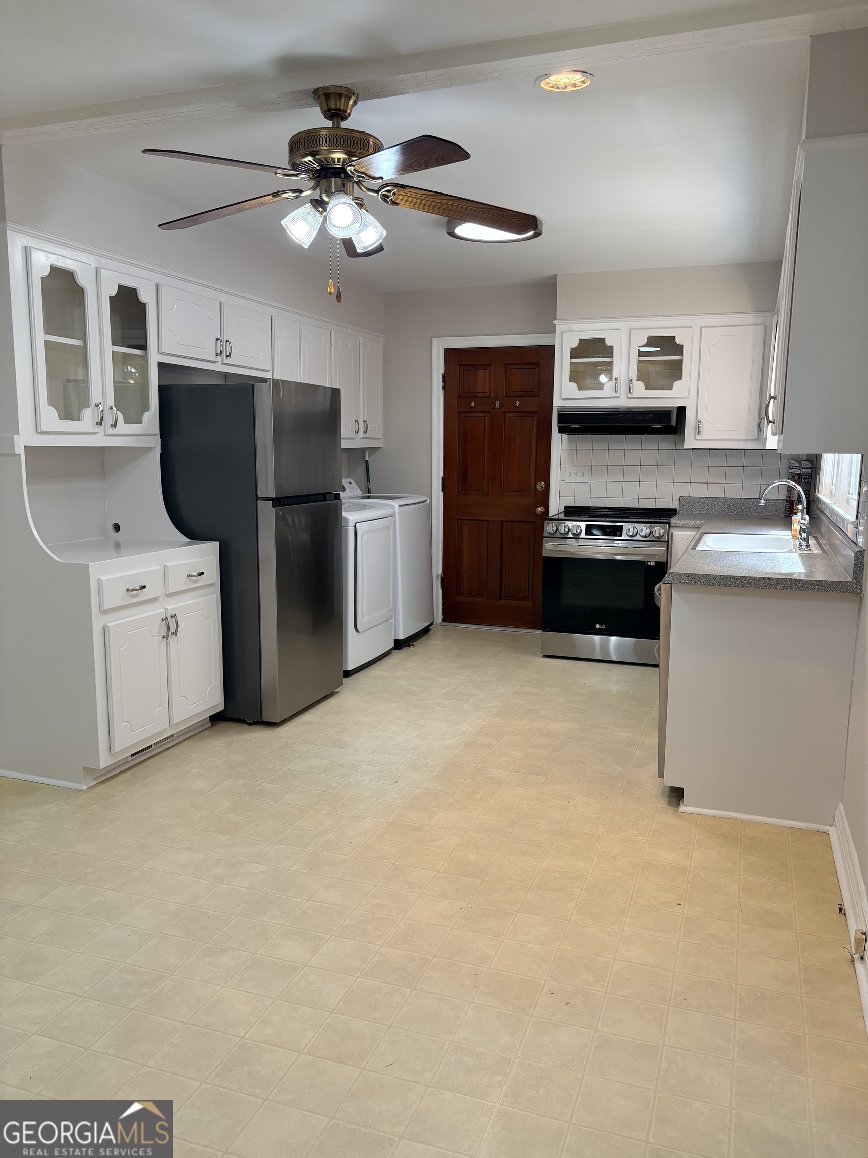 218 Flora Avenue Southeast Rome, GA 30161 - Photo 12 of 24 a kitchen with stainless steel appliances a stove refrigerator sink and cabinets