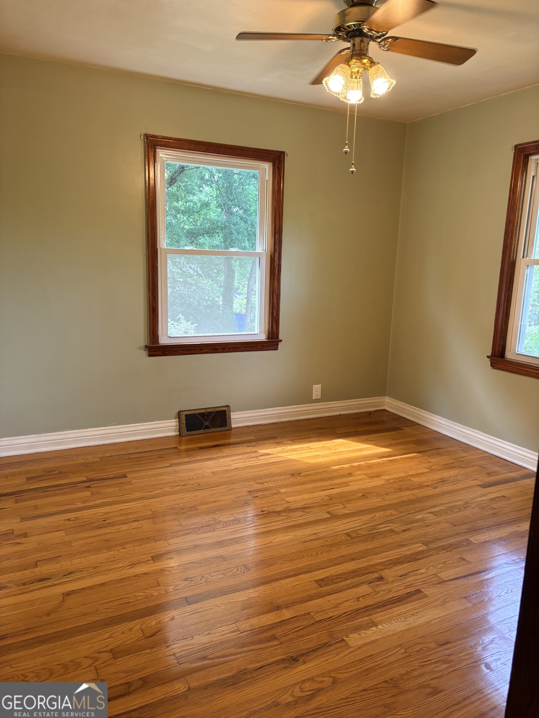 218 Flora Avenue Southeast Rome, GA 30161 - Photo 17 of 24 a view of an empty room with wooden floor and a window