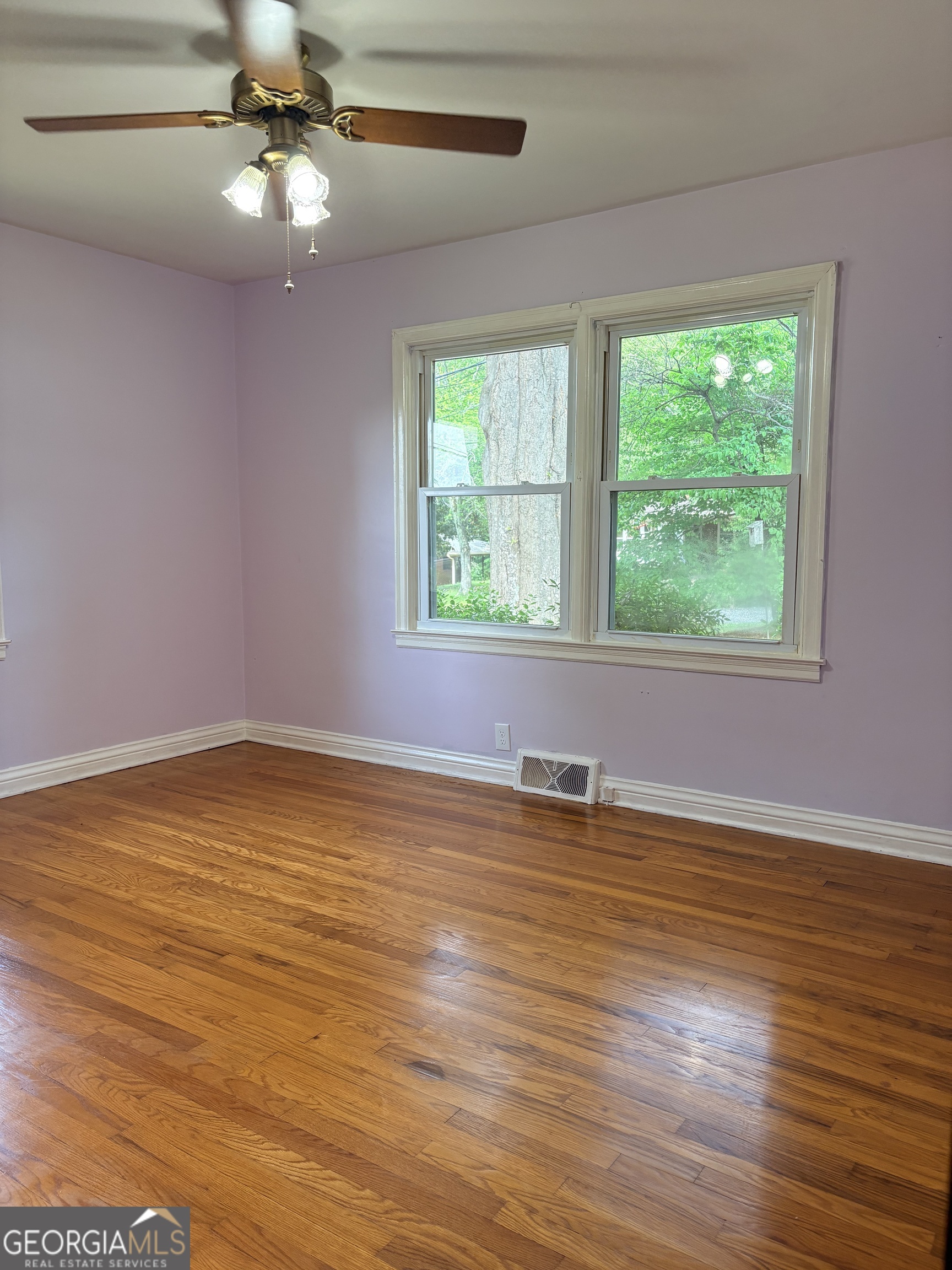 218 Flora Avenue Southeast Rome, GA 30161 - Photo 18 of 24 a view of an empty room with wooden floor and a window