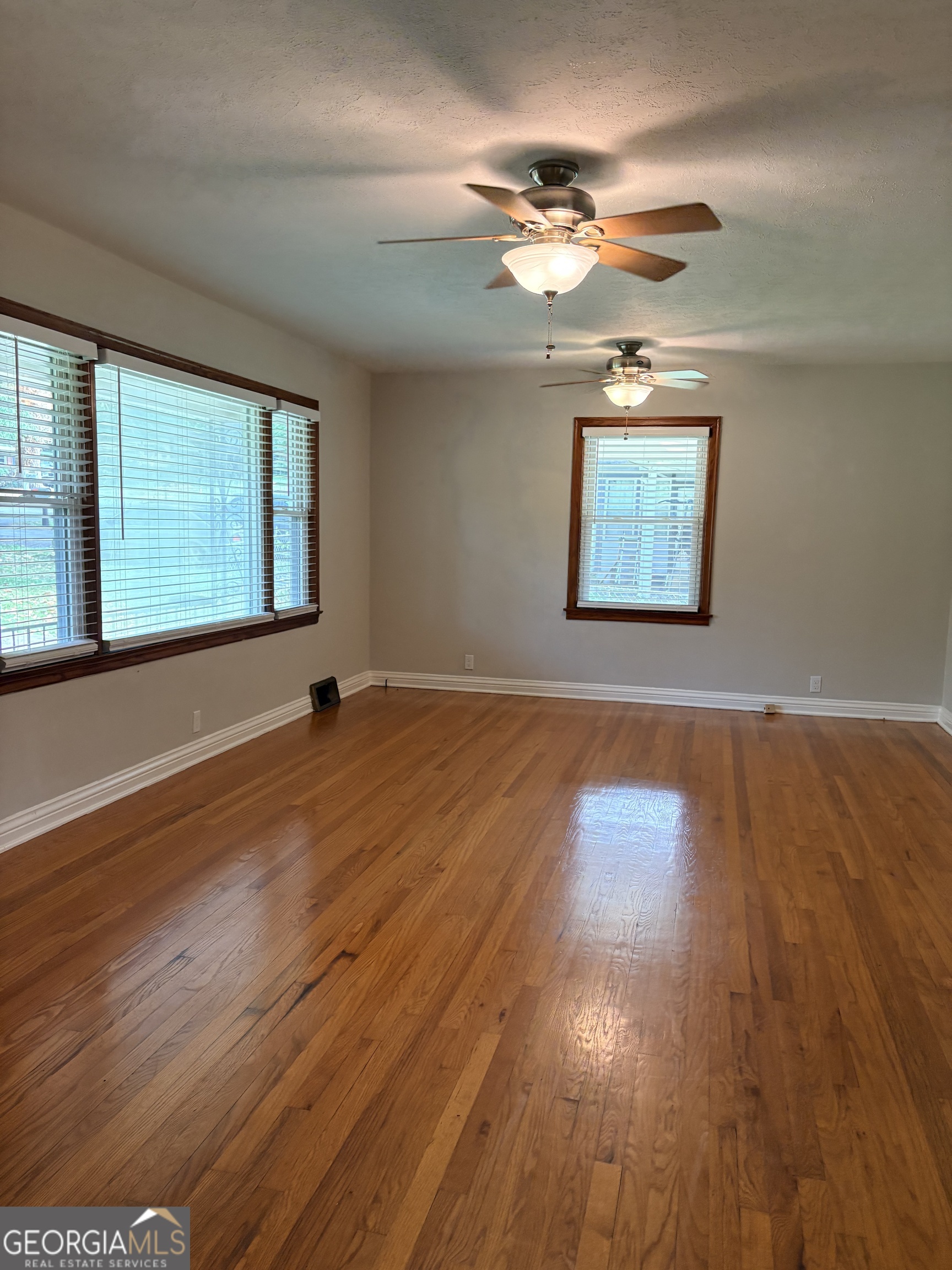 218 Flora Avenue Southeast Rome, GA 30161 - Photo 9 of 24 a view of an empty room with wooden floor and a window