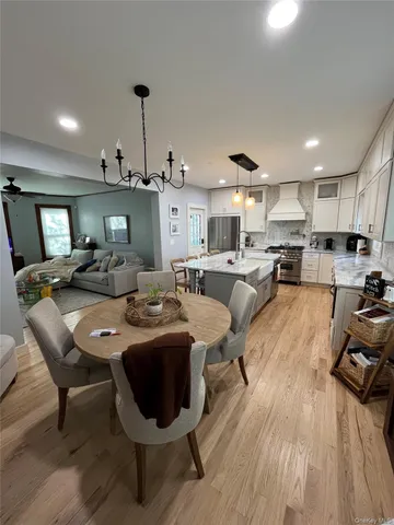 a kitchen with kitchen island a sink stove and wooden floor