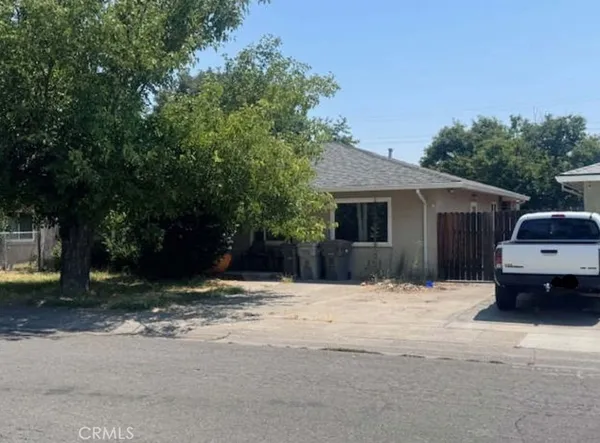 a house that has a tree in front of it