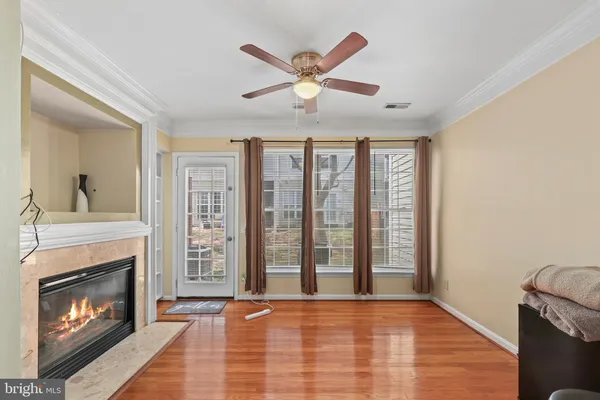 a view of livingroom with fireplace fan and windows