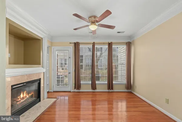 a view of an empty room with window and fireplace