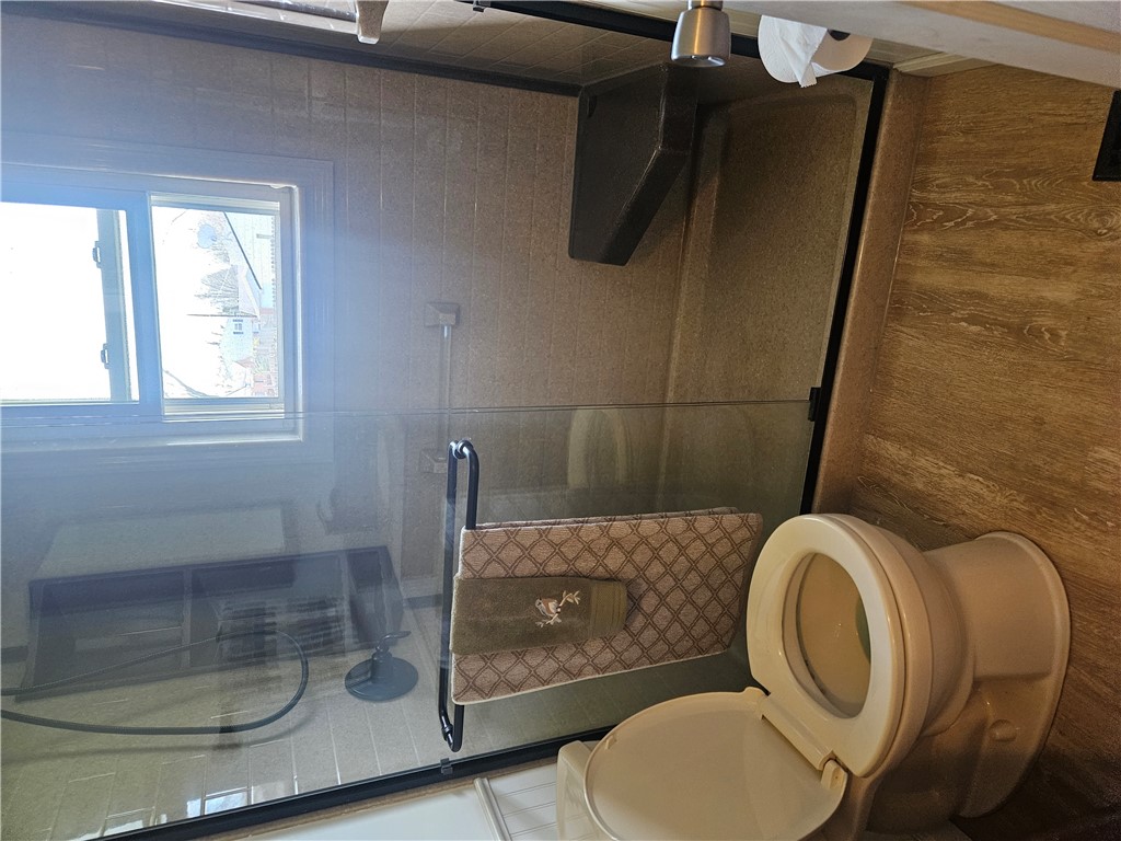 6510 Longford Road Dayton, OH 45424 - Photo 21 of 27 This bathroom provides a well-appointed space with a convenient toilet and a sleek glass-enclosed shower.