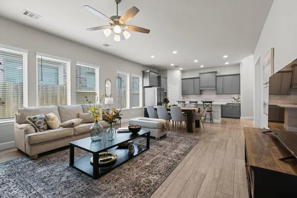 a living room with furniture fireplace and a table