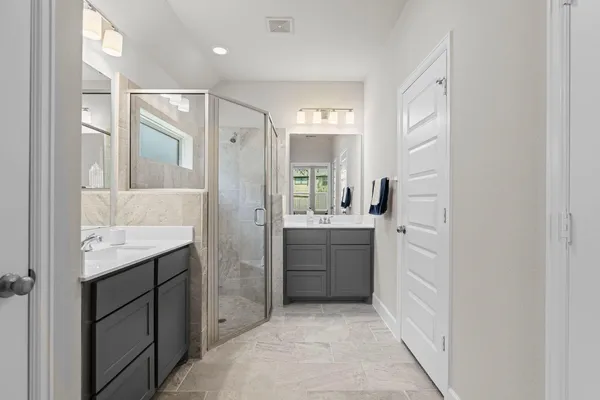 a bathroom with a granite countertop sink a mirror a bathtub and shower