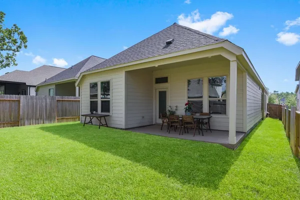 a view of a house with a yard and sitting area