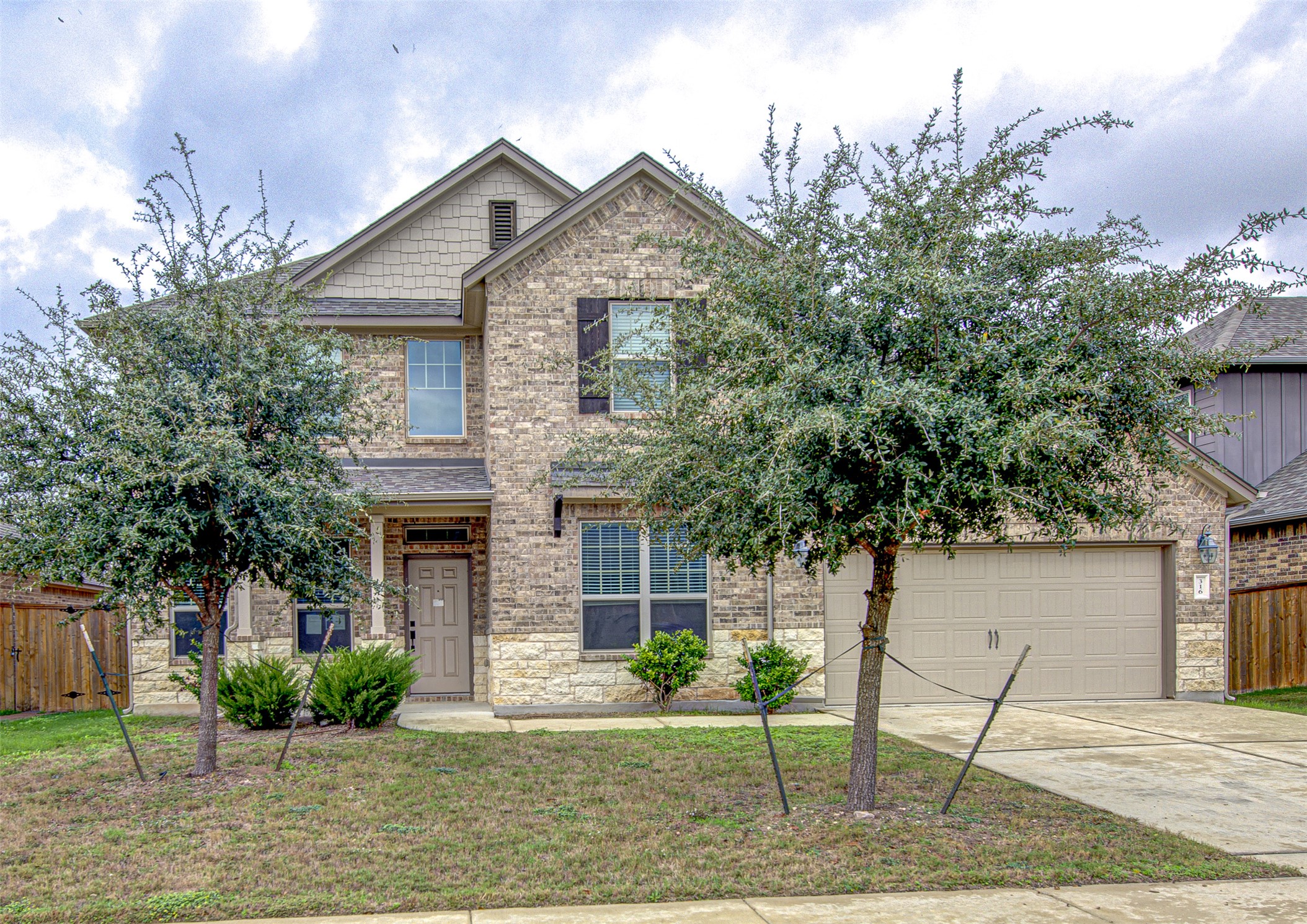 316 Buffalo Ridge Drive Manchaca, TX 78652 - Photo 1 of 37 a front view of a house with garden