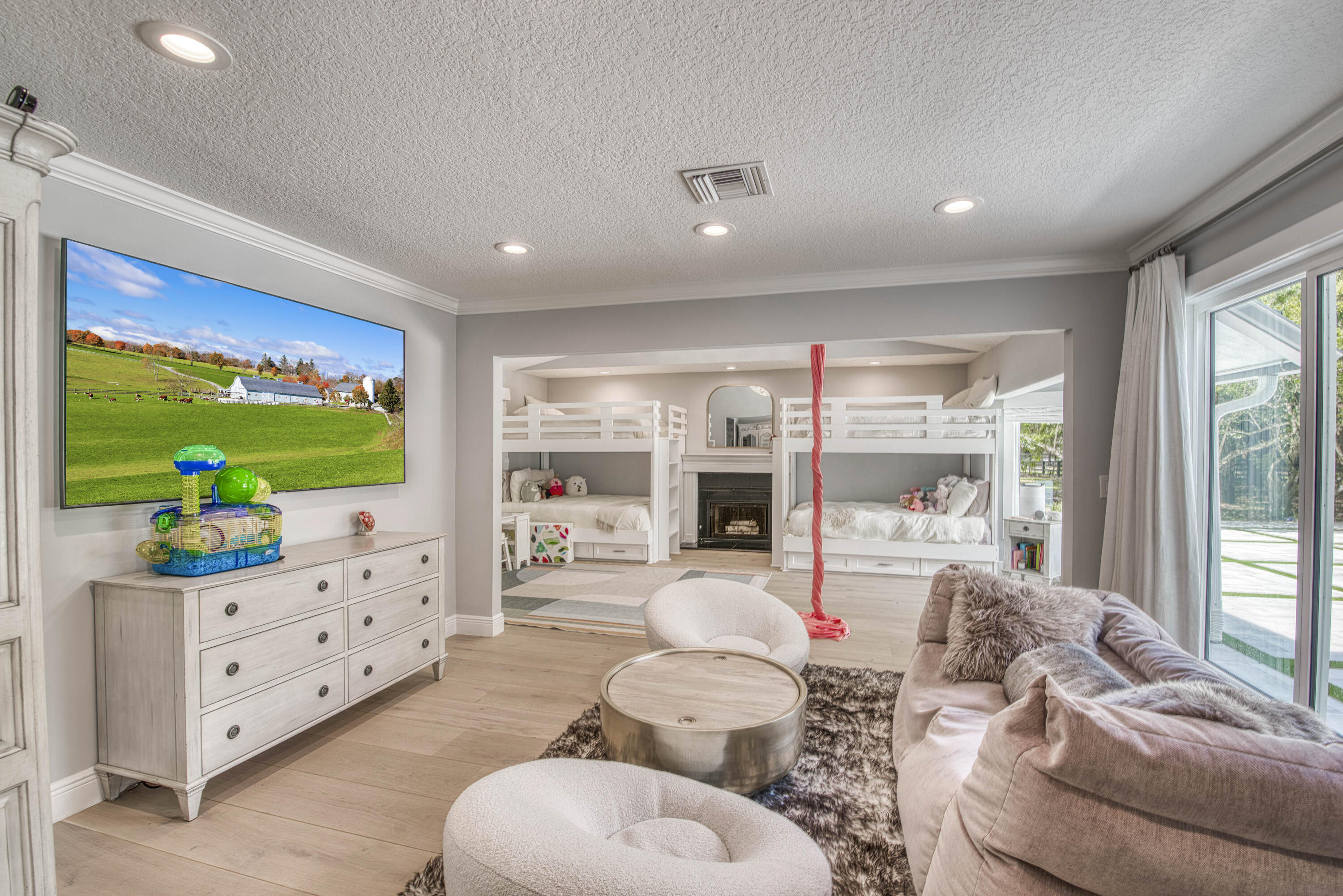 13395 Running Water Road Palm Beach Gardens, FL 33418 - Photo 37 of 112 a living room with furniture a flat screen tv and a floor to ceiling window