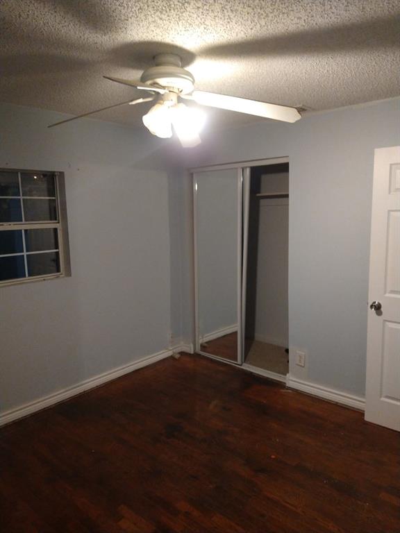 2817 Hickory Street Abilene, TX 79601 - Photo 3 of 11 an empty room with wooden floor and windows