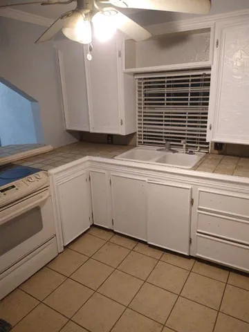 a kitchen with a sink and cabinets