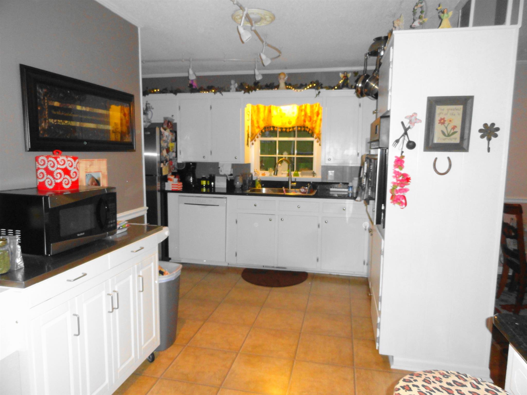 1711 Ann Road Lawrenceburg, TN 38464 - Photo 8 of 29 a kitchen with stainless steel appliances a stove a microwave a refrigerator and cabinets