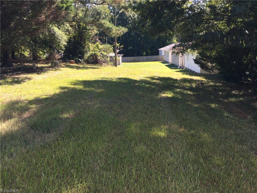 1017 Sales Street High Point, NC 27260 - Photo 15 of 40 Backyard: Here we can see the open backyard area. Great for a nice family garden, the nice green grass and mature trees. Room enough for some family games, maybe badminton or some volleyball.