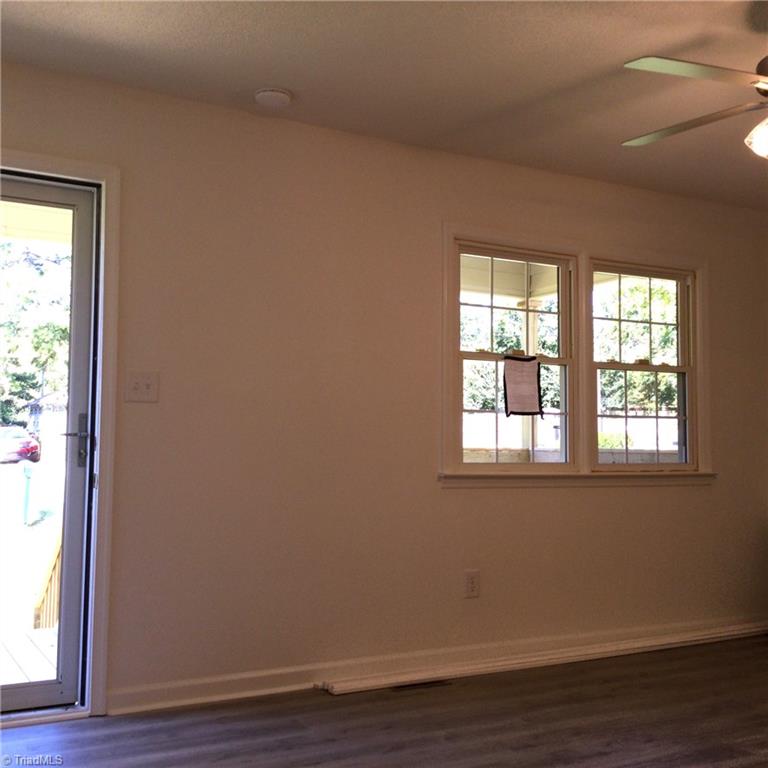 1017 Sales Street High Point, NC 27260 - Photo 35 of 40 Living Room: Features include vinyl plank flooring for easy cleaning, 2 windows for natural lighting, fresh new paint and a ceiling fan with light. You have an open floor plan with the living room, dining room and kitchen areas.
