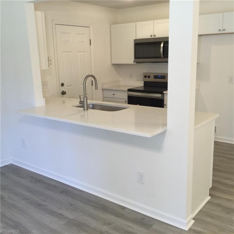 1017 Sales Street High Point, NC 27260 - Photo 19 of 40 View into the kitchen from the Living Room showing the snack bar for casual dining or extra sitting area for a family gathering.