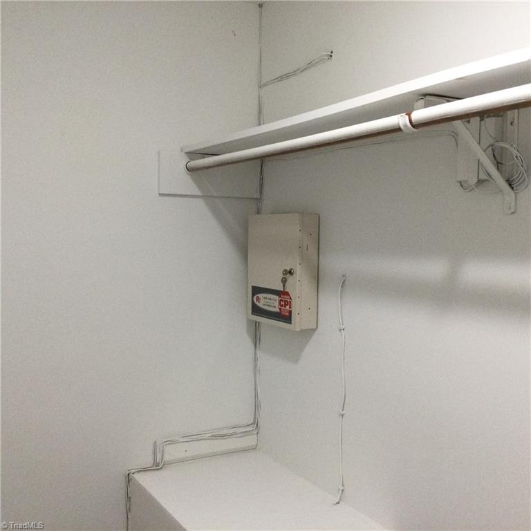 1017 Sales Street High Point, NC 27260 - Photo 25 of 40 Primary En-Suite Bathroom - Lighted WIC: Features include carpet flooring, lighting, fresh new paint, storage shelf and rack.