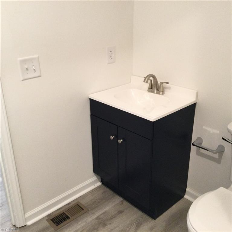 1017 Sales Street High Point, NC 27260 - Photo 32 of 40 Main Hall Bathroom: Features include vinyl plank flooring for easy cleaning, fresh new paint and a decorative vanity with new fixtures.