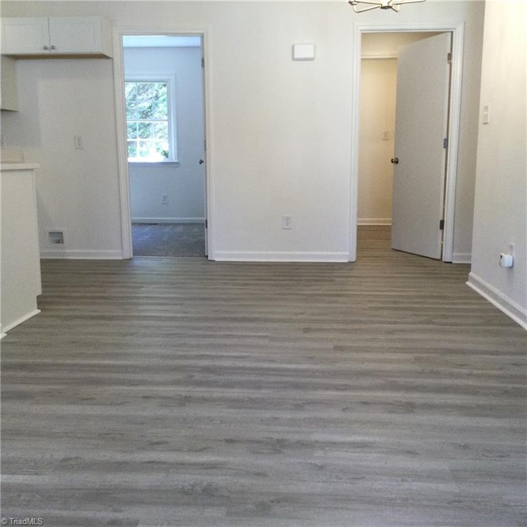 Dining Room: Features include vinyl plank flooring for easy cleaning, fresh new paint and the overhead light. The kitchen is to the left side, bedroom 3 is to the left of center and the main hall bathroom is right of center and bedroom 2 is down the hall to the right side.