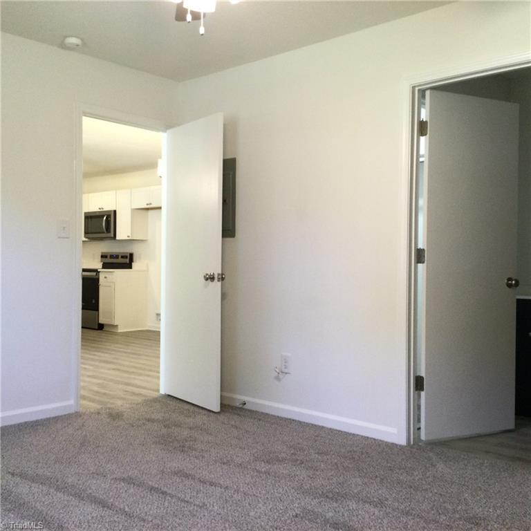 Primary Bedroom: Features include carpet flooring to help keep you warm on cool mornings, a window for natural lighting, fresh new paint and a ceiling fan with light. The open door on the left is to the Living Room and the En-Suite bathroom and WIC is to the right side