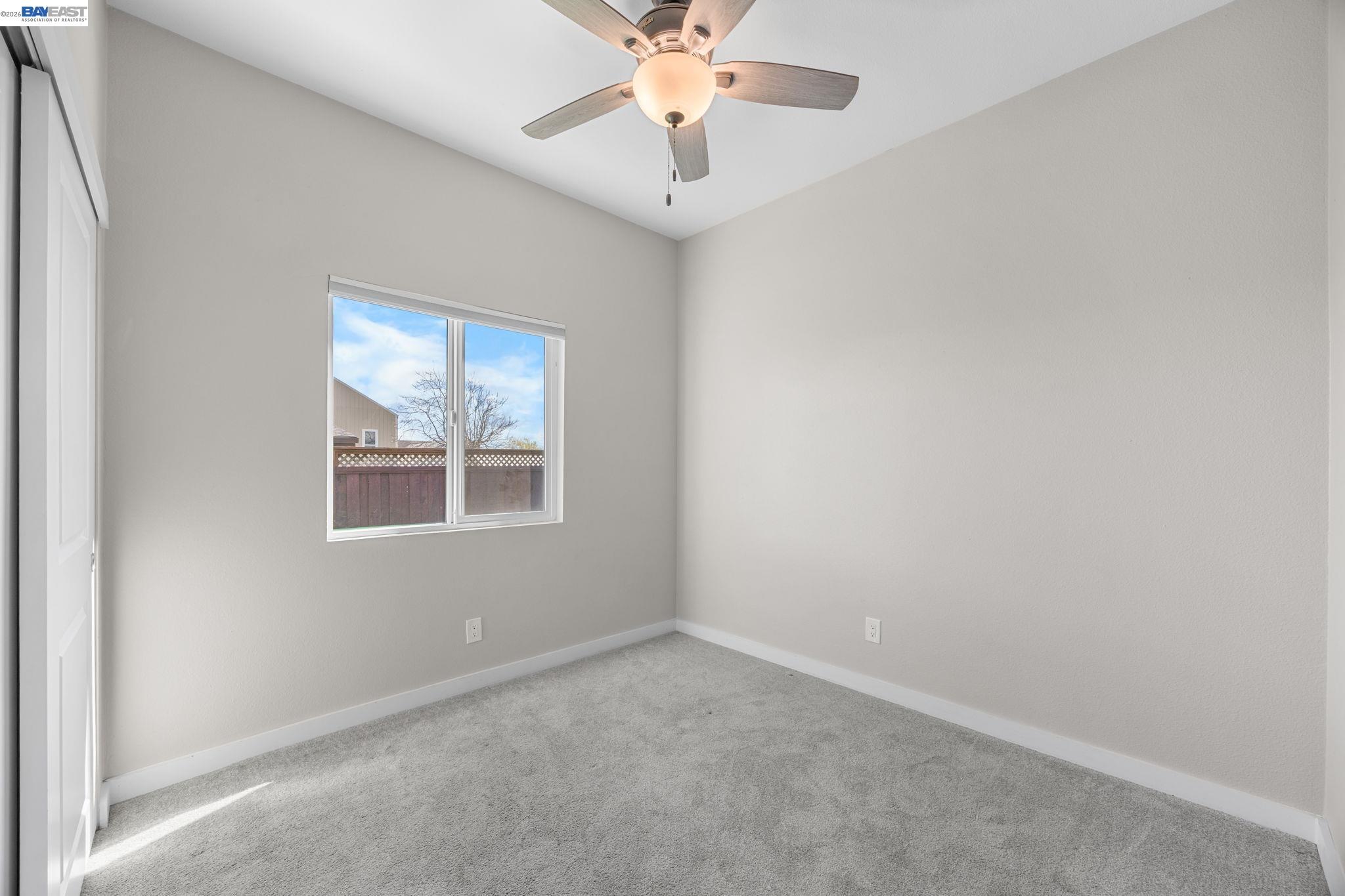47 North 2nd Street Rio Vista, CA 94571 - Photo 17 of 42 an empty room with chandelier fan and windows