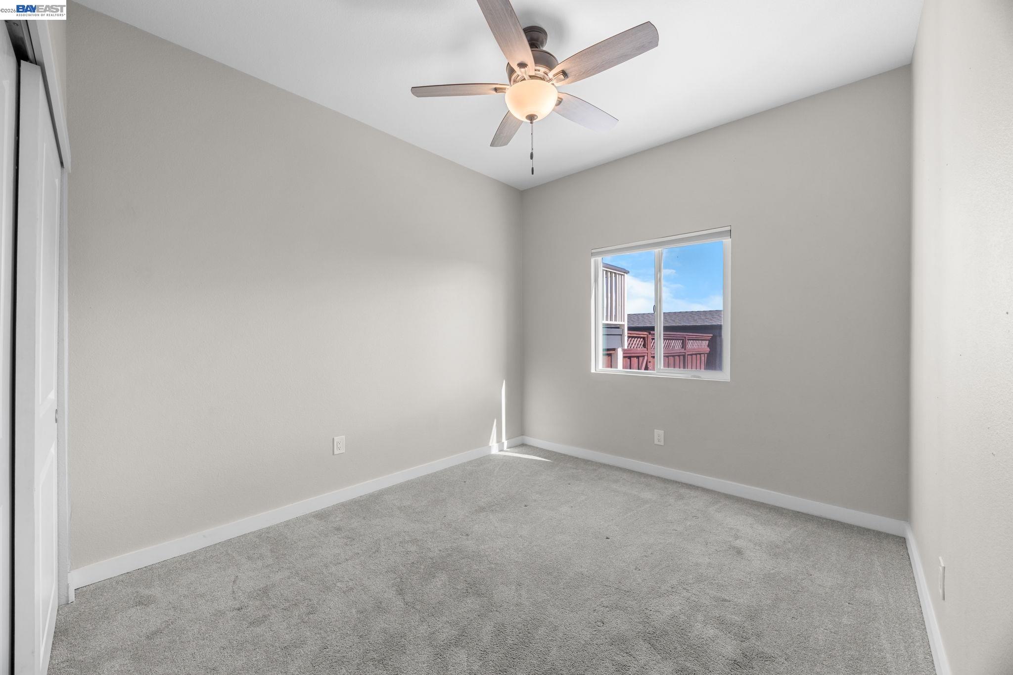 47 North 2nd Street Rio Vista, CA 94571 - Photo 18 of 42 an empty room with a window and a fan