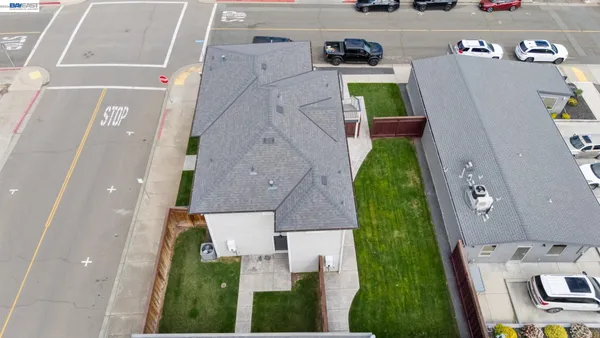 an aerial view of residential houses with outdoor space