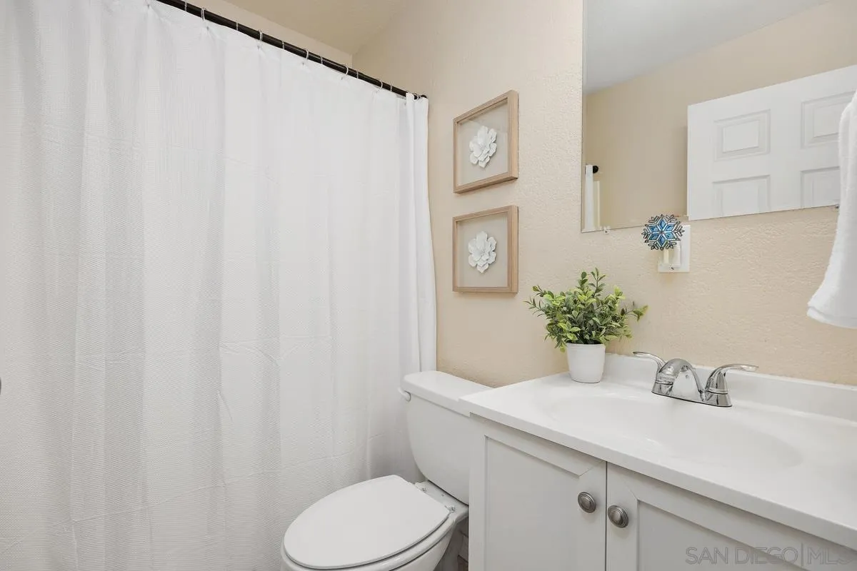13961 Eastern Street Poway, CA 92064 - Photo 18 of 29 a bathroom with a granite countertop sink and a toilet