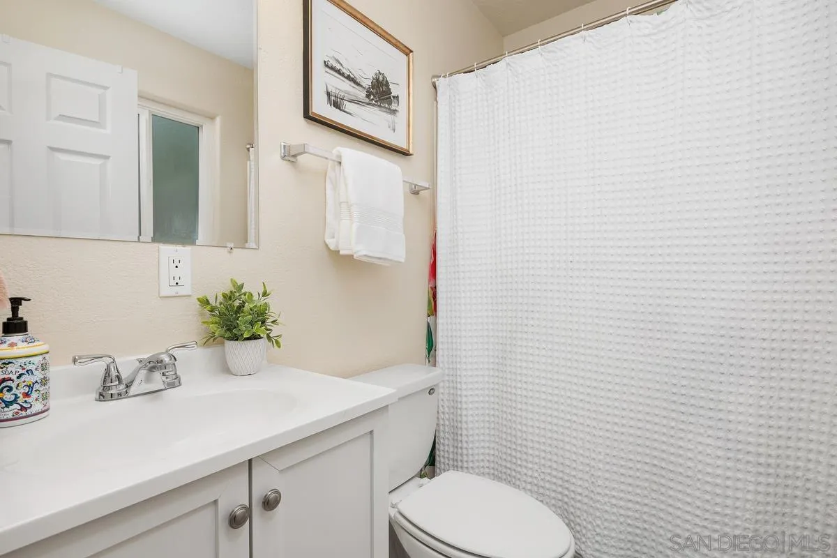 13961 Eastern Street Poway, CA 92064 - Photo 19 of 29 a bathroom with a granite countertop sink and a toilet