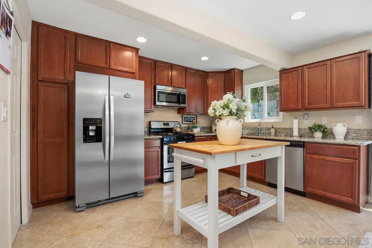 13961 Eastern Street Poway, CA 92064 - Photo 9 of 29 a kitchen with kitchen island a counter top space appliances and cabinets
