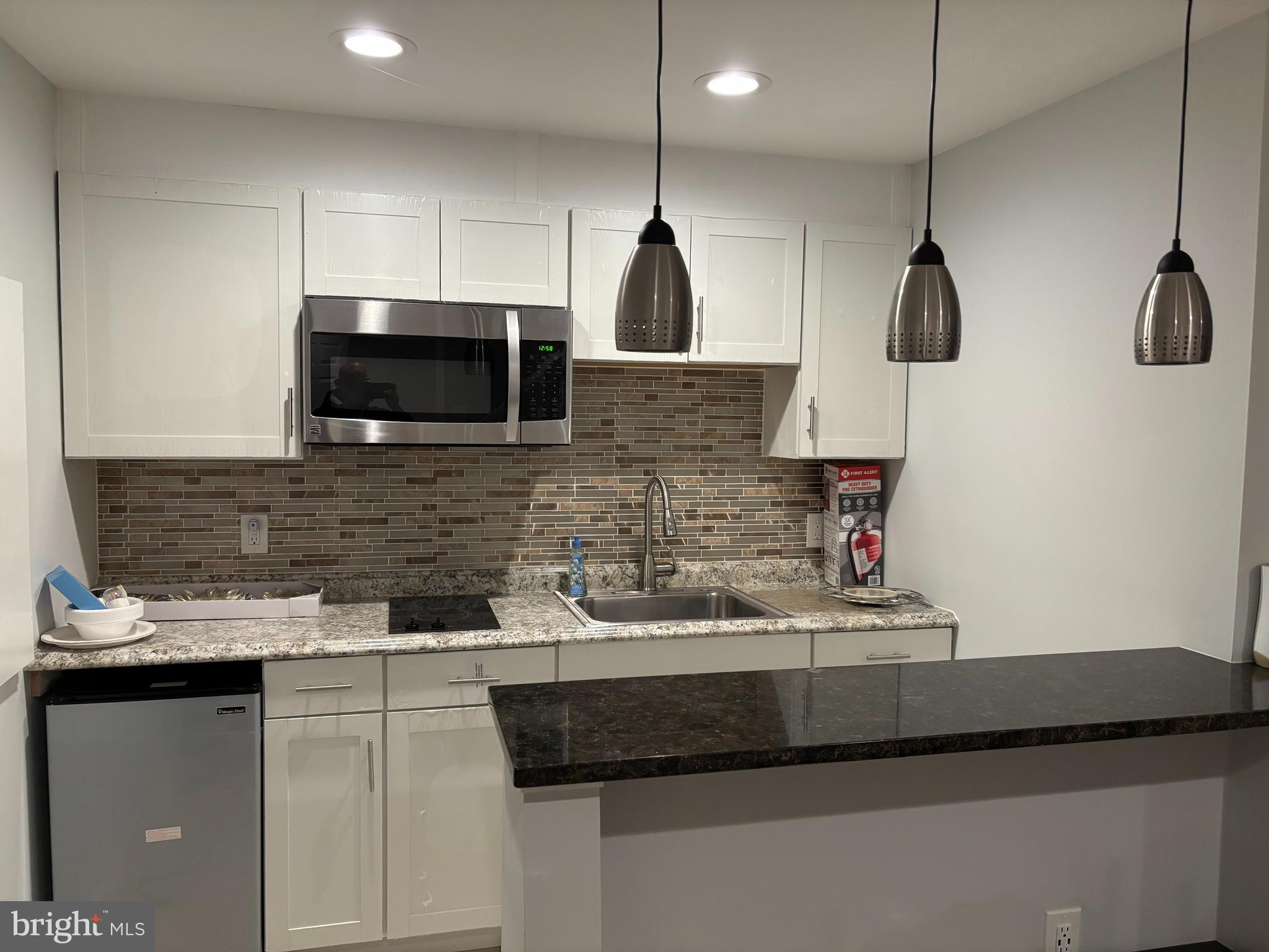 44140 Bristow Circle Ashburn, VA 20147 - Photo 2 of 14 a kitchen with stainless steel appliances granite countertop a sink a microwave a stove and a refrigerator