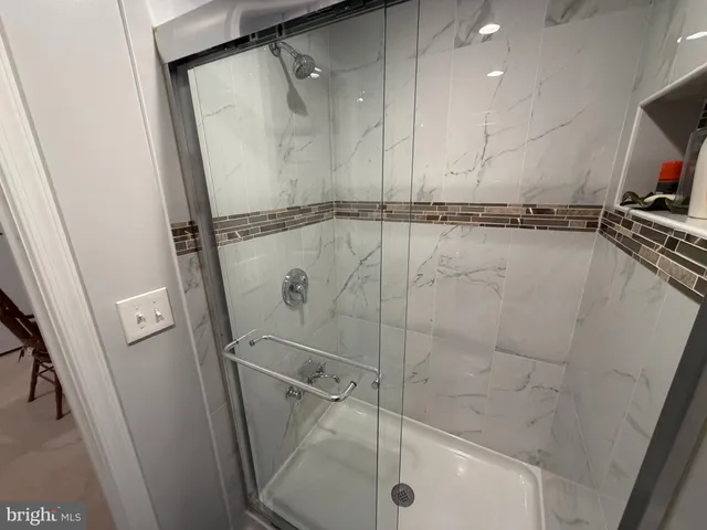 a bathroom with a shower and a sink