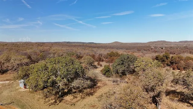 a view of a mountain in the distance in a field
