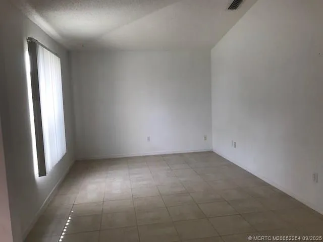 an empty room with windows and closet