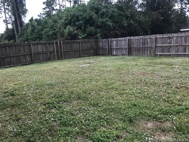 a view of a backyard with a fence