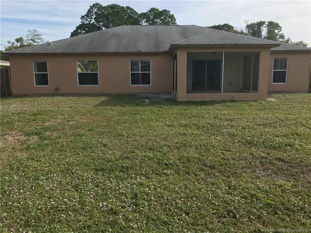 a house that has a tree in front of it