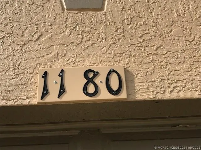 a wooden door with a sign and a yard