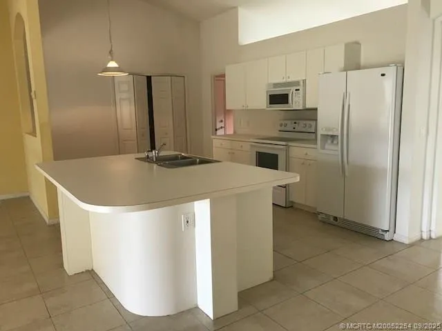 a kitchen with stainless steel appliances a refrigerator a stove a sink and a counter top space