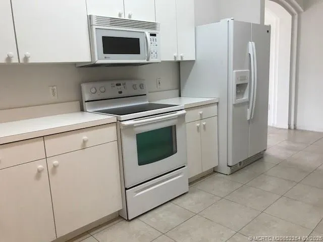 a kitchen with stainless steel appliances a refrigerator sink and microwave