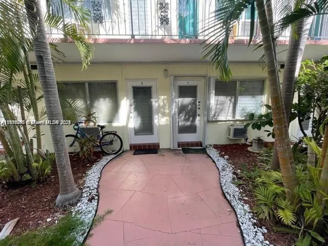 a view of a house with potted plants and a patio