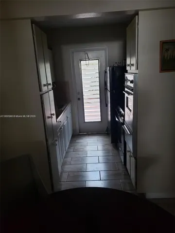 a view of a hallway with wooden floor and stairs