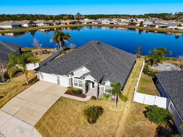 an aerial view of a house with outdoor seating