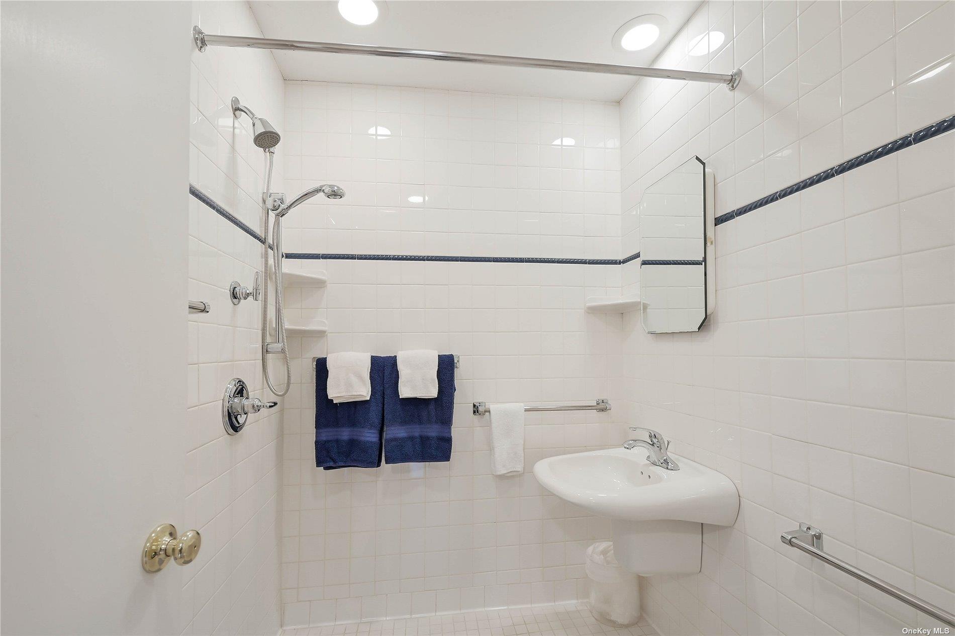 415 Southern Cross Road Cutchogue, NY 11935 - Photo 11 of 14 a bathroom with a sink and mirror