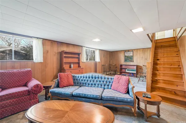 a living room with furniture and a lamp