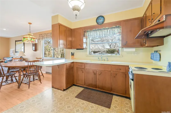 a kitchen with sink cabinets and dining table