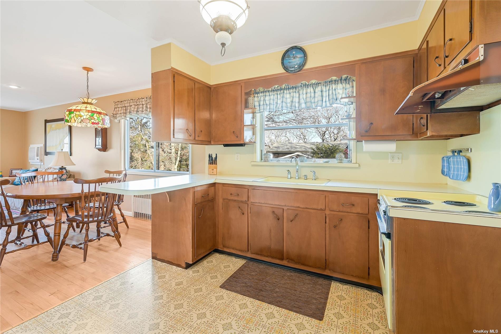 415 Southern Cross Road Cutchogue, NY 11935 - Photo 5 of 14 a kitchen with sink cabinets and dining table