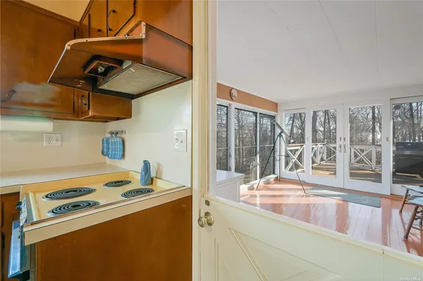 a kitchen with stainless steel appliances granite countertop a sink and a stove next to a window