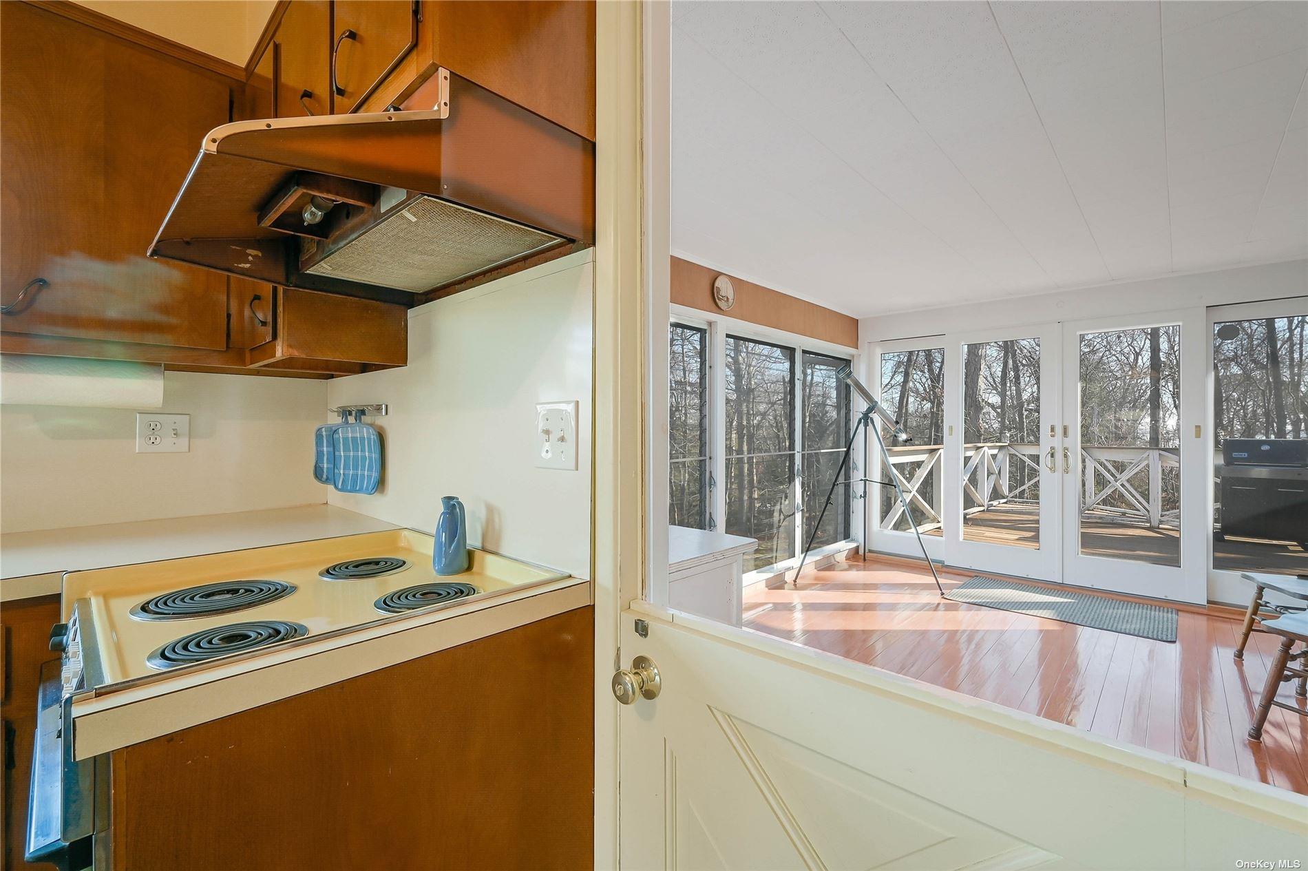 415 Southern Cross Road Cutchogue, NY 11935 - Photo 6 of 14 a kitchen with stainless steel appliances granite countertop a sink and a stove next to a window