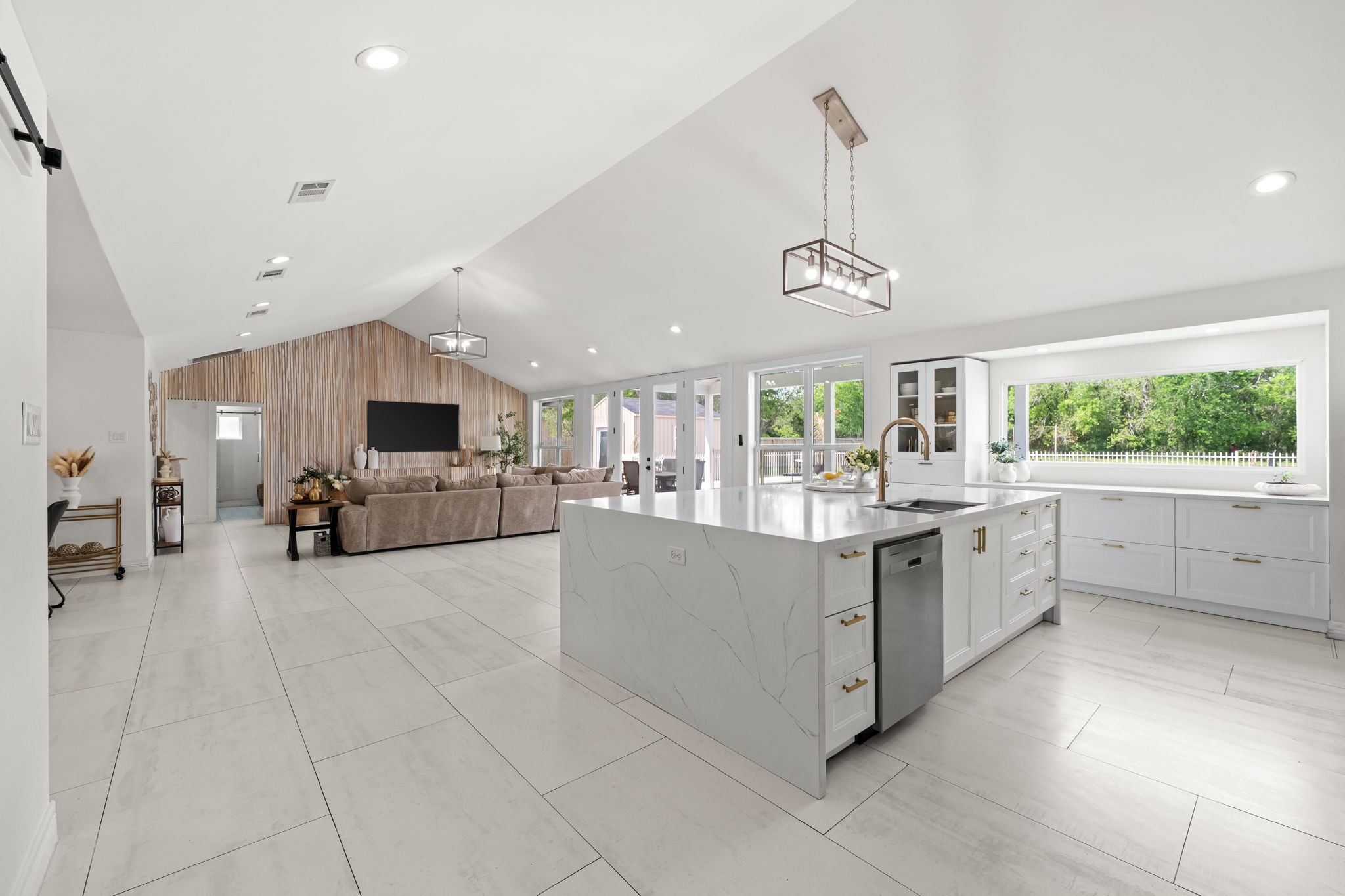 8800 Brae Acres Road Houston, TX 77074 - Photo 10 of 48 The island is fitted with an undermount sink, dishwasher, and additional pot/pan drawers. Perimeter cabinetry is draped in natural light, and the family room opens in the distance beyond — the kitchen never feels like a closed-off room.