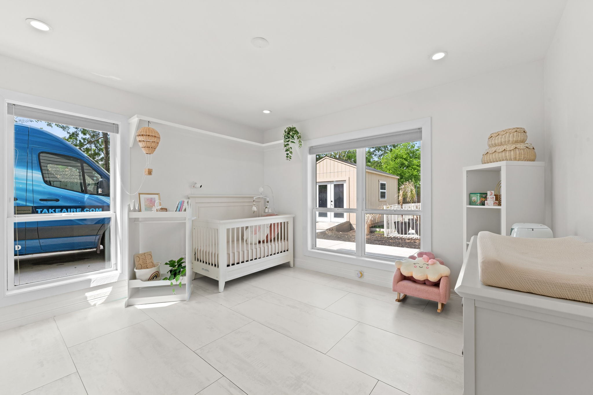 8800 Brae Acres Road Houston, TX 77074 - Photo 16 of 48 This secondary bedroom has two large windows on the front wall that fill the space with natural light and large-format tile floors and recessed lighting carry the same clean finish as the rest of the home.